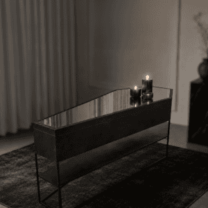 Elegant black console table with candles in a modern interior setting.