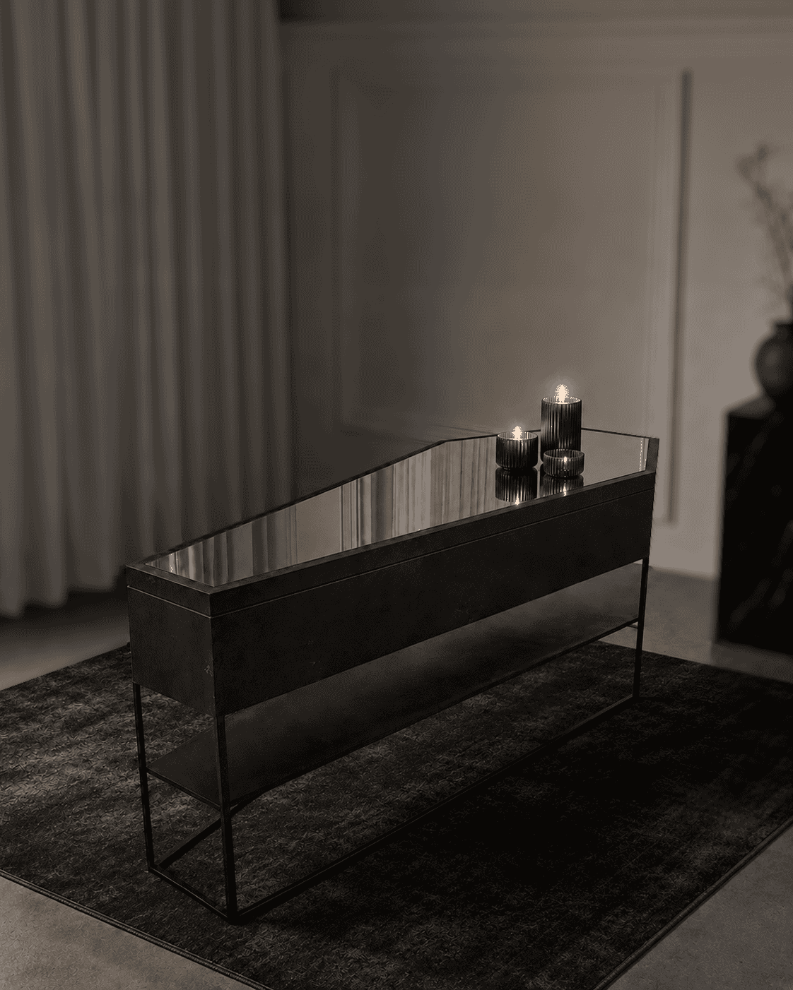 Elegant black console table with candles in a modern interior setting.